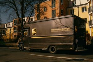 UPS delivery truck parked on a sunny street in a residential neighborhood.